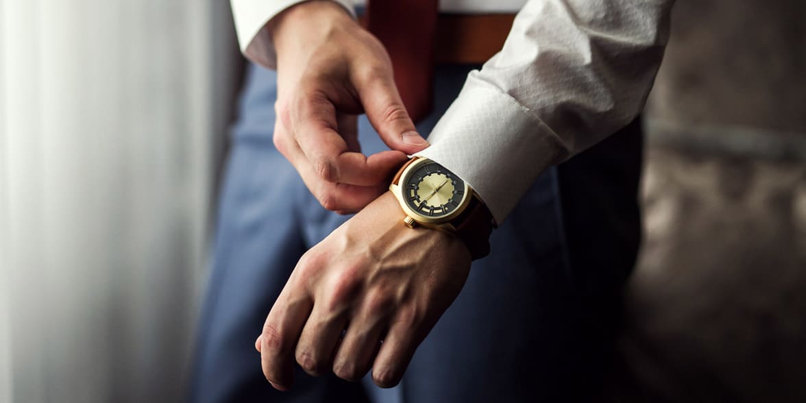 Photo of a man putting on a watch